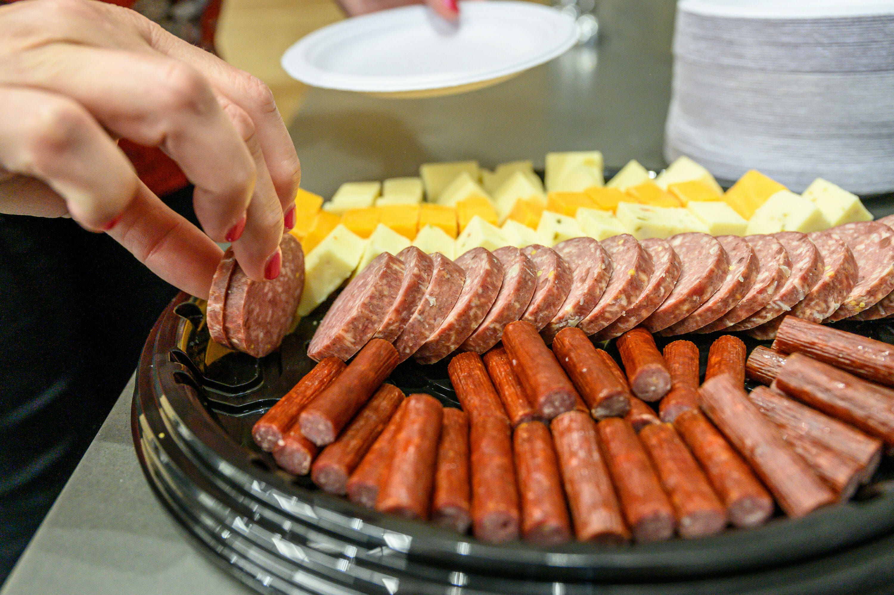 Members of the USDA Senate Agriculture Appropriations Subcommittee staff taste samples of sausage, meat sticks, and cheese