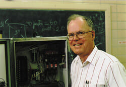 picture of Robert L Bradley in front of a chalkboard